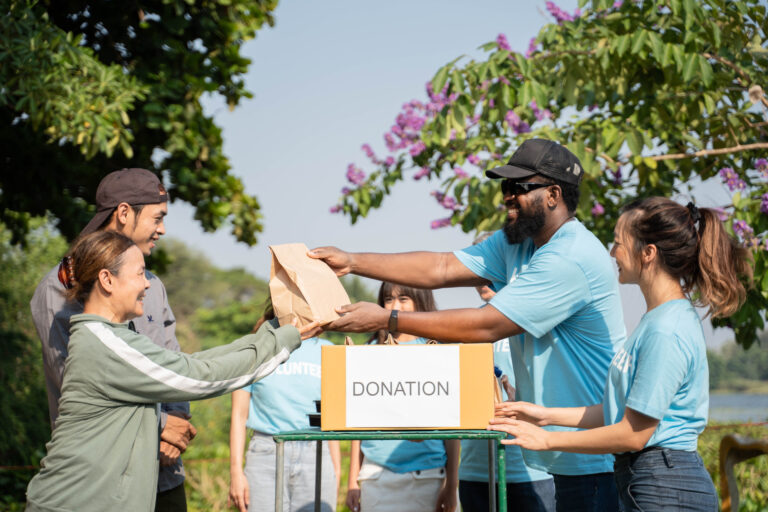 Team of volunteers holding donations boxes in outdoor
